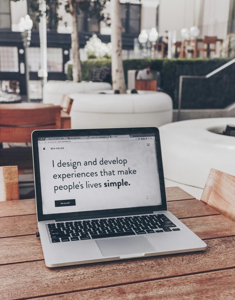 Designer building a professional website on a laptop